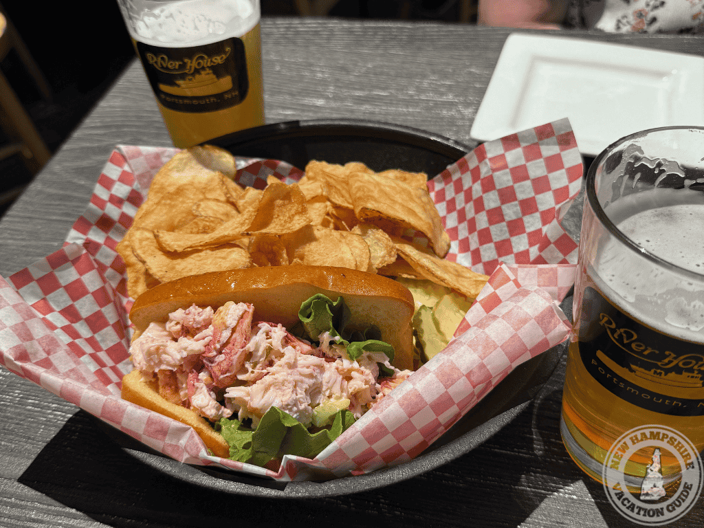 lobster roll and chips in a basket on a table at River House restaurant outdoor deck in Portsmouth NH