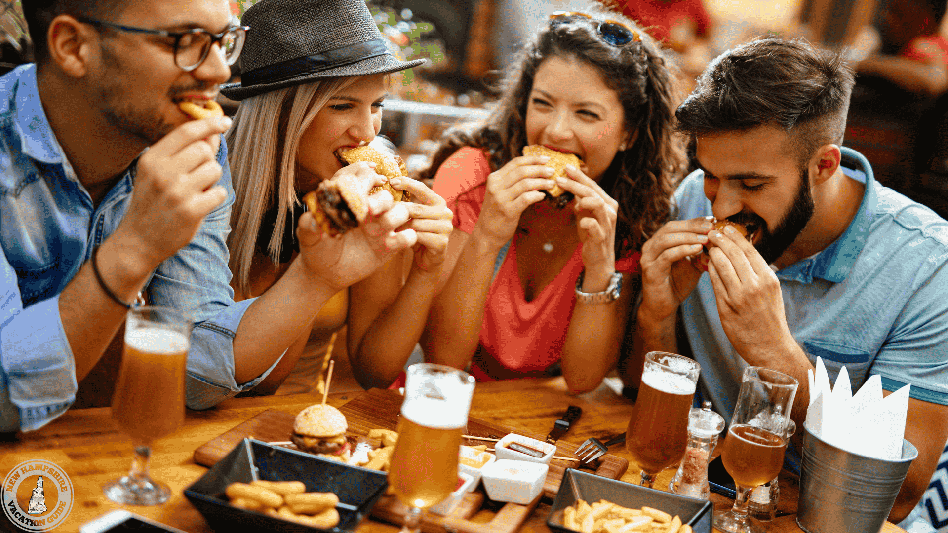 people eating delicious food and enjoying drinks at a restaurant table