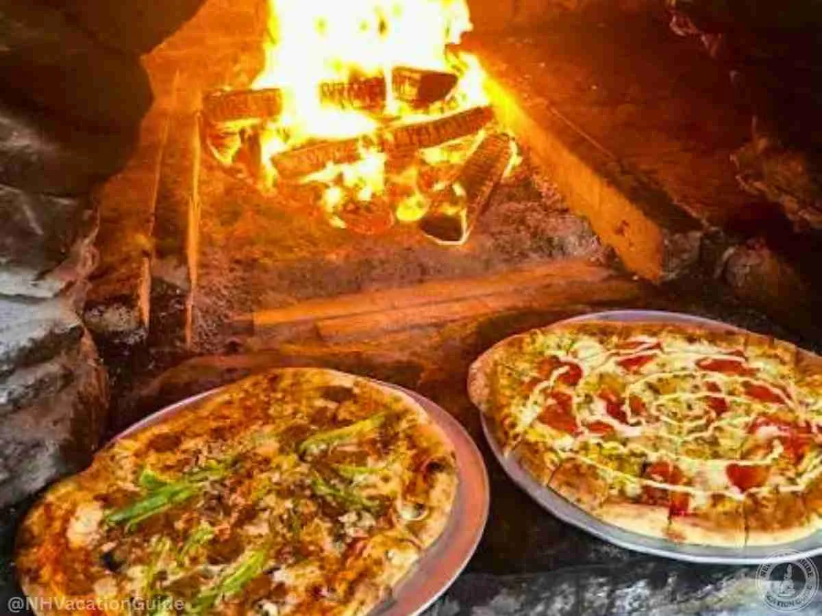 Flatbread Company Pizza Oven with two pizzas and fire in north conway nh